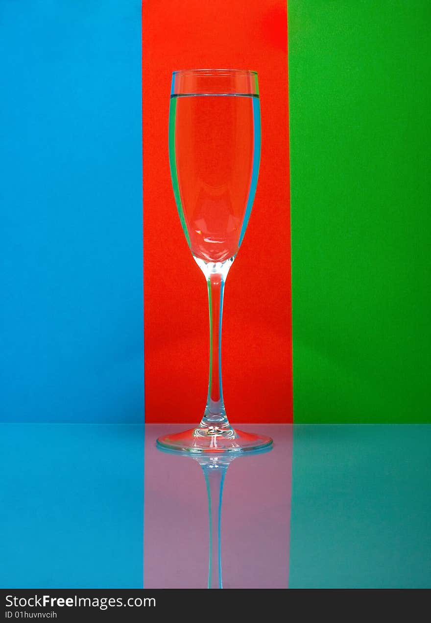 One wineglass on color background