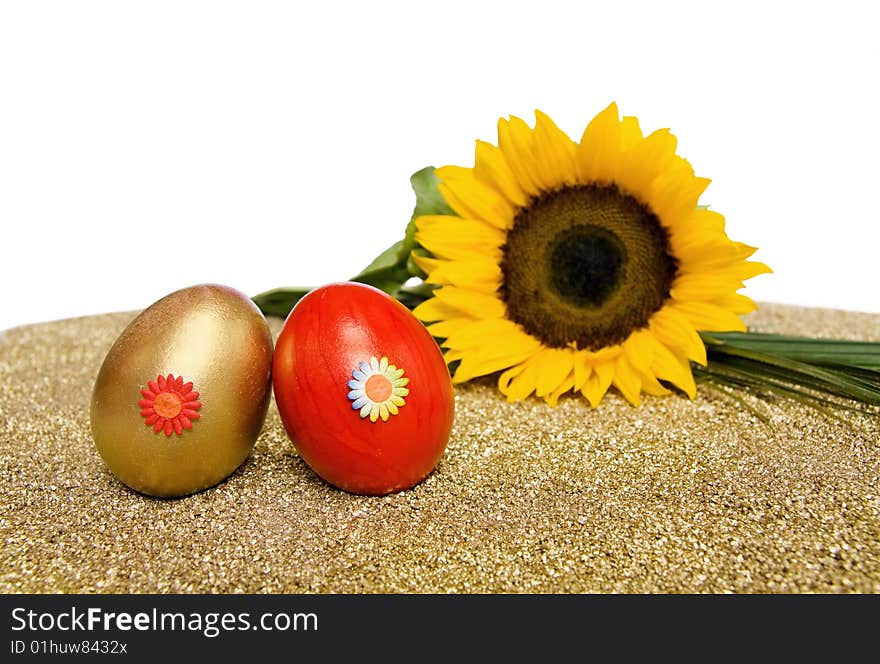 Easter spring celebration with red and golden decorated eggs and sunflower. Isolated over white with clipping path included. Easter spring celebration with red and golden decorated eggs and sunflower. Isolated over white with clipping path included.