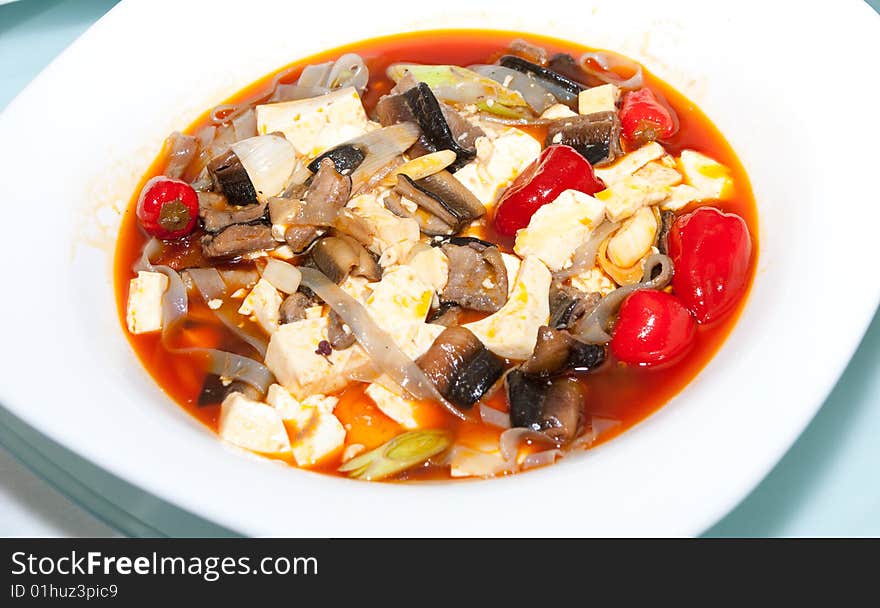 Delicious Chinese dish in white plate on restaurant table. Delicious Chinese dish in white plate on restaurant table