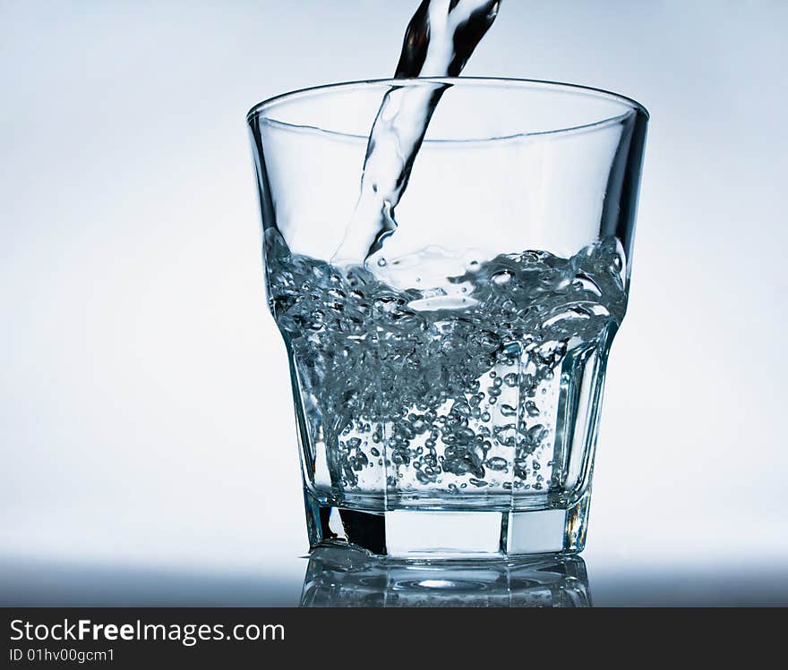 Glass of pouring water with a bubbles