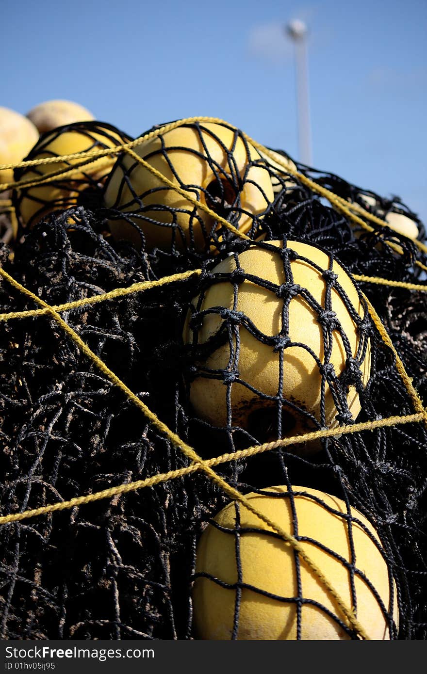 Close view of several floaters and fishing net on the docks. Close view of several floaters and fishing net on the docks.