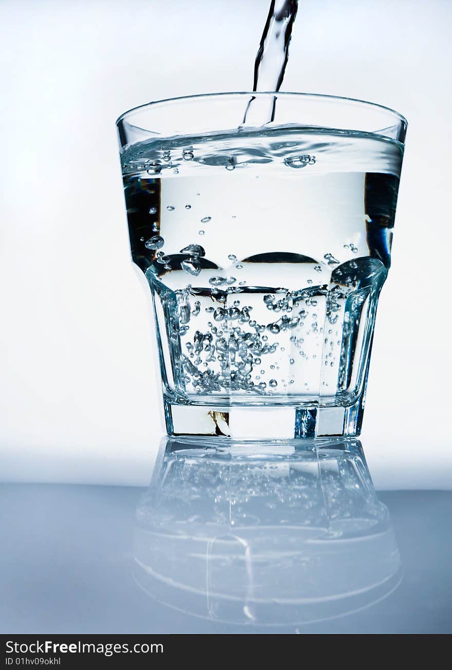 Glass of pouring water with a bubbles