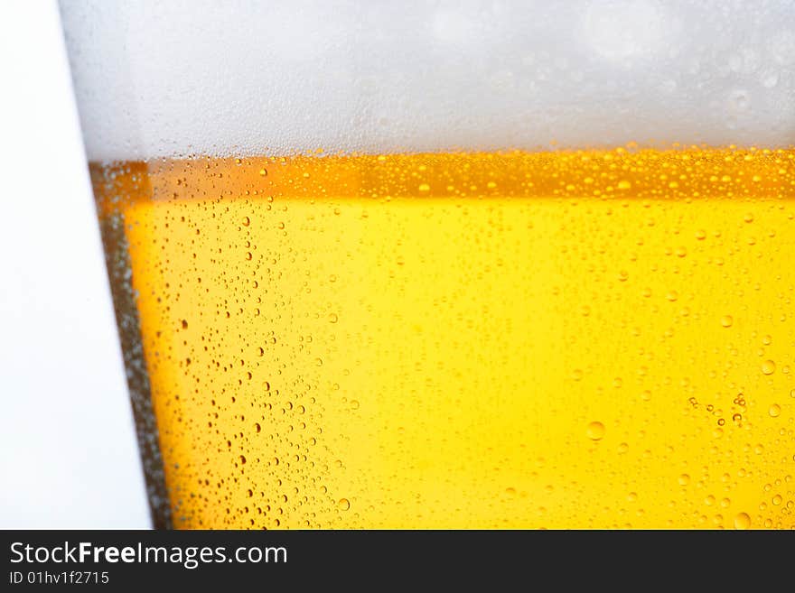 Fresh glass of pils beer with froth and condensed water pearls. Fresh glass of pils beer with froth and condensed water pearls