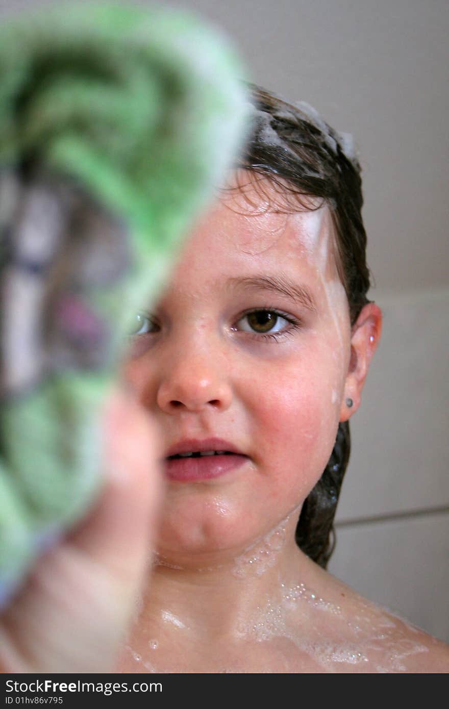 A Child is playing in the bathtub. A Child is playing in the bathtub