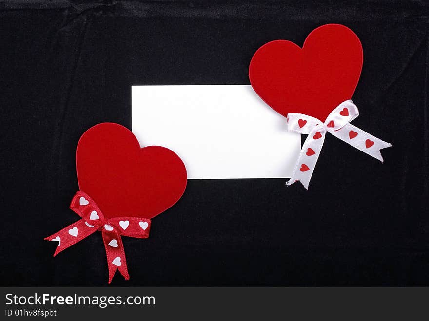 Two hearts and white card.