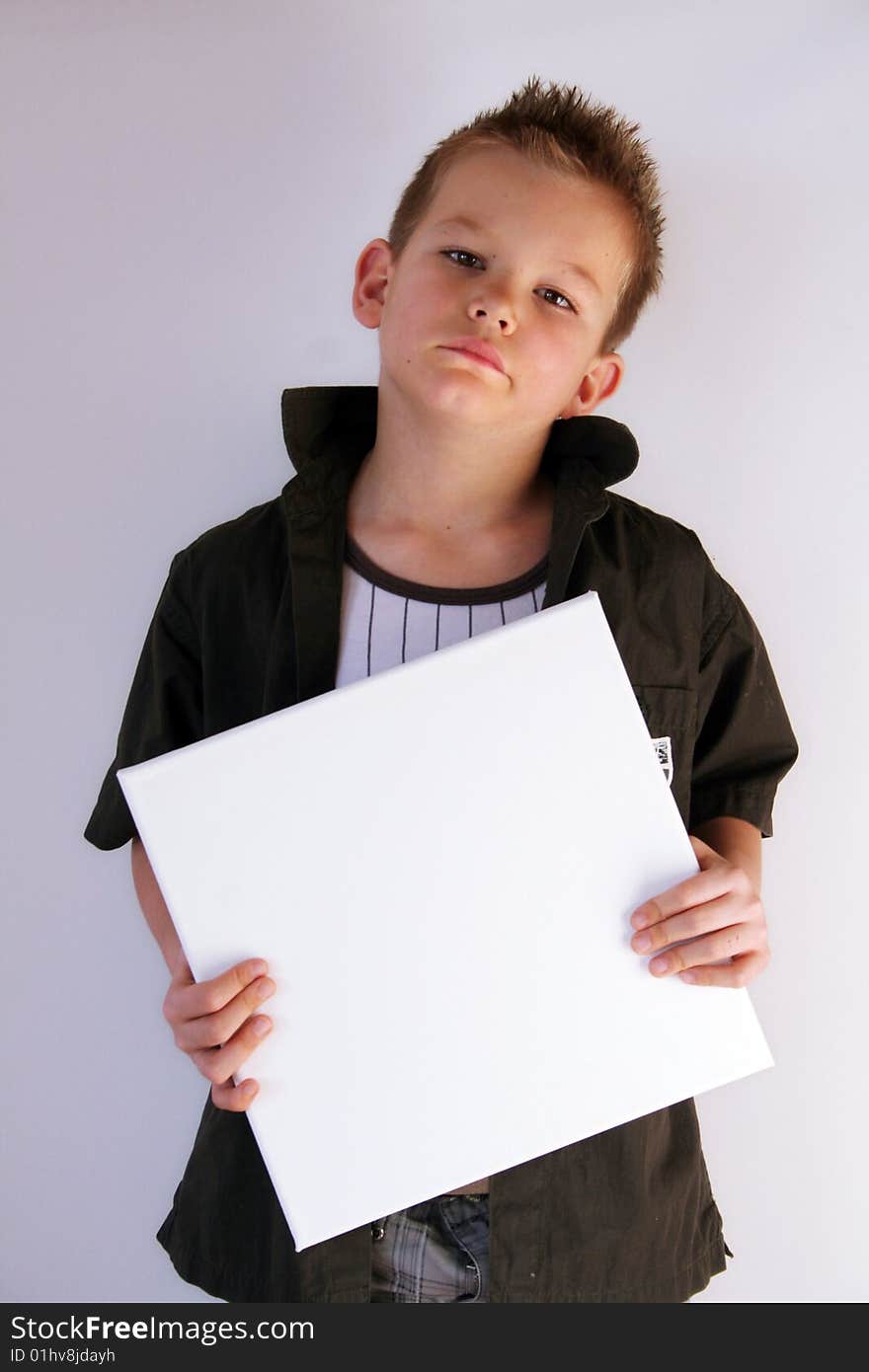 A boy is holding a frame in his hands. A boy is holding a frame in his hands