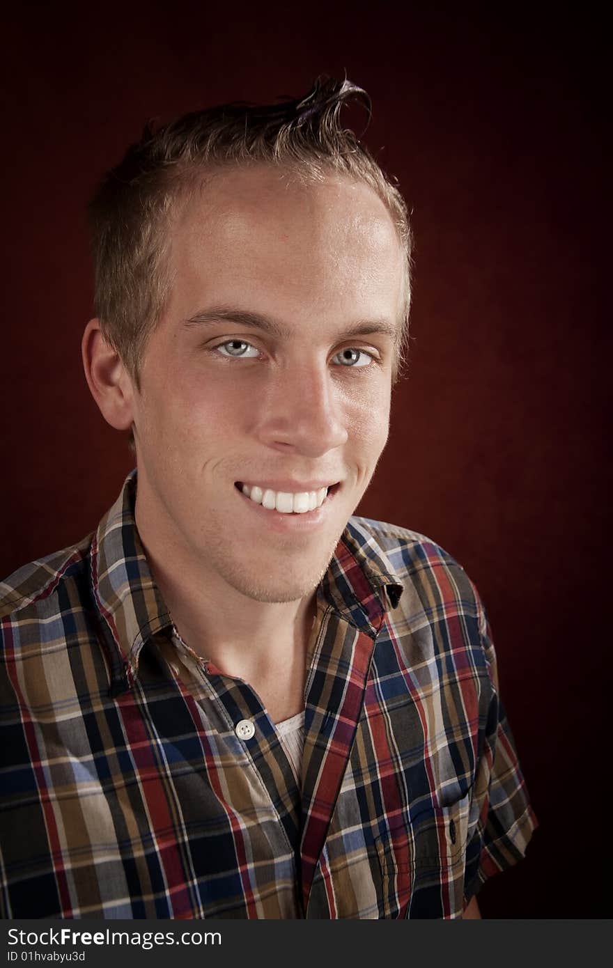 Portrait of handsome young blonde man in plaid shirt. Portrait of handsome young blonde man in plaid shirt