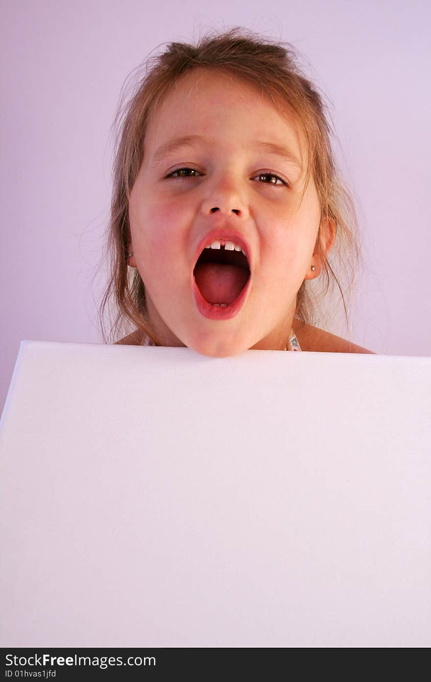 A girl is holding a frame in her hands. A girl is holding a frame in her hands