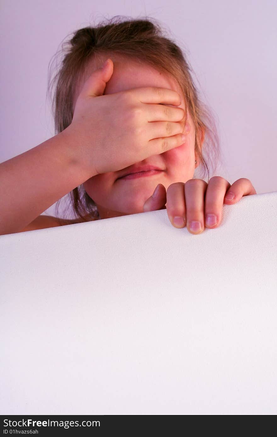 A girl is holding a frame in her hands. A girl is holding a frame in her hands