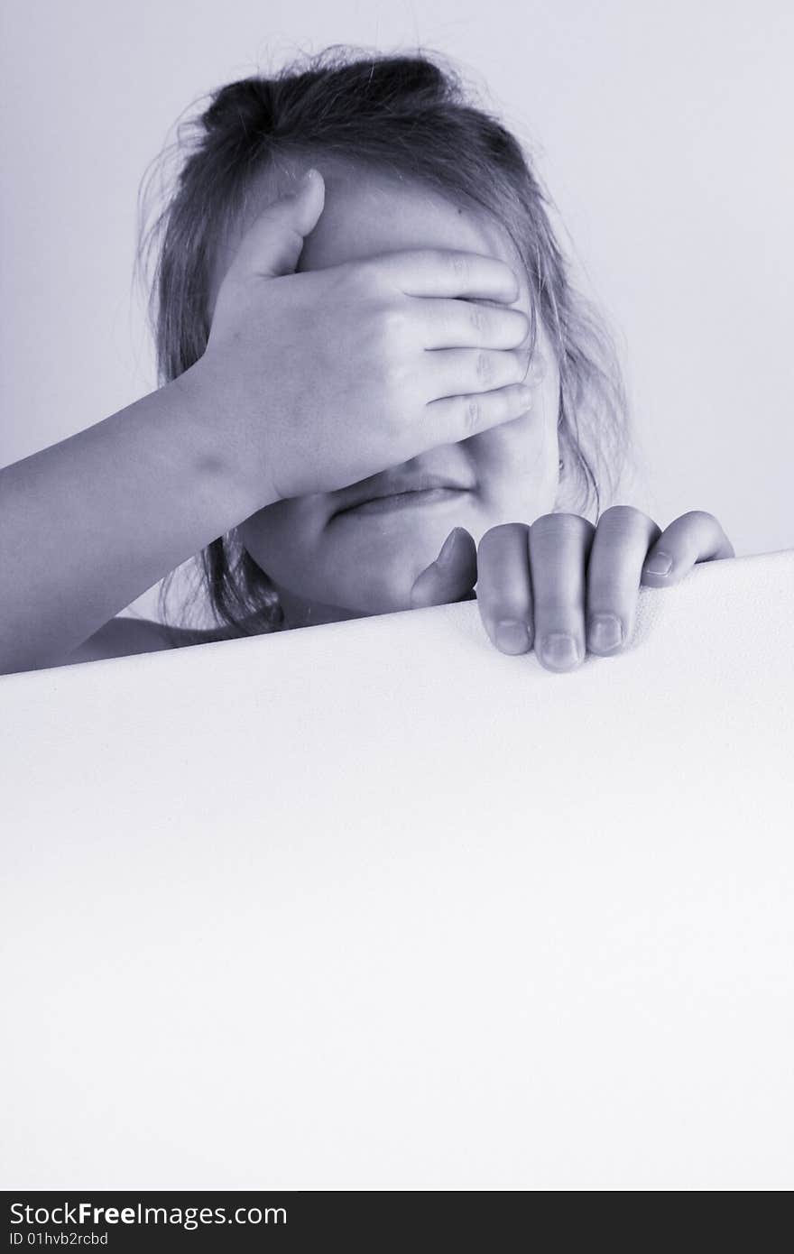 A girl is holding a frame in her hands. A girl is holding a frame in her hands