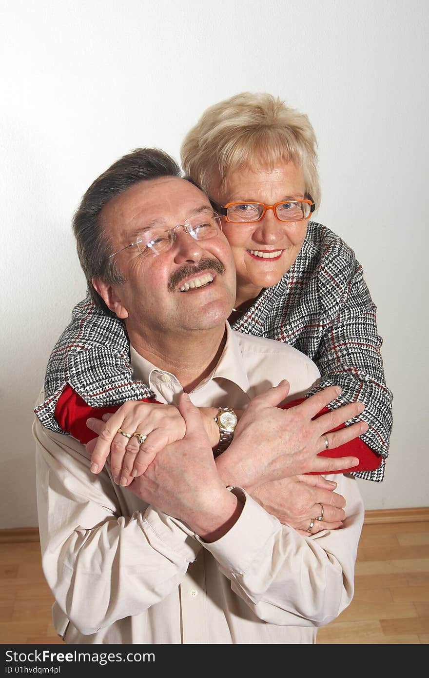 Happy old couple at home with copyspace. Isolated over pure white. Happy old couple at home with copyspace. Isolated over pure white.