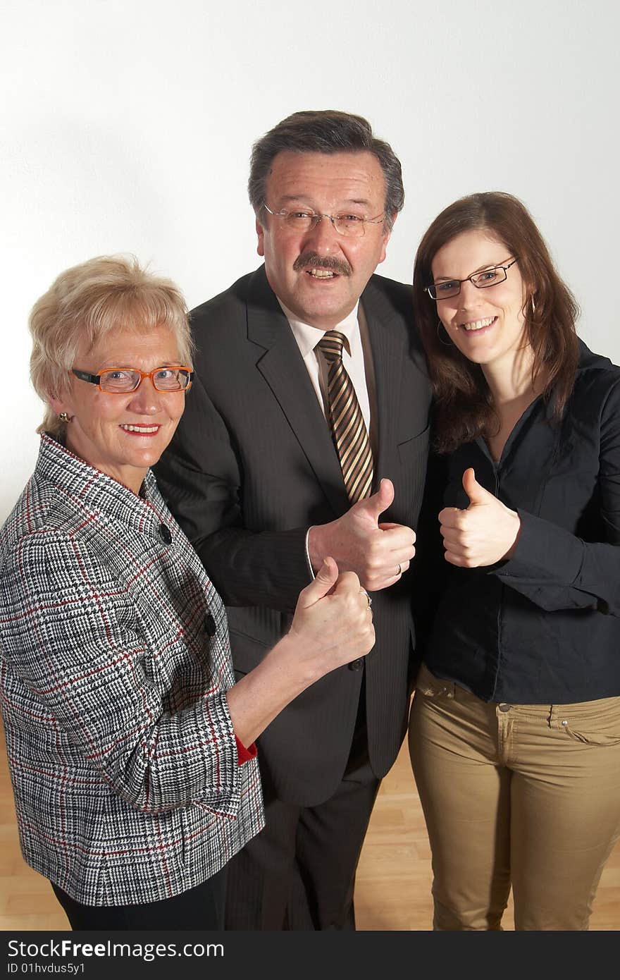 Senior business team with a young female worker giving thumbs up sign!. Senior business team with a young female worker giving thumbs up sign!