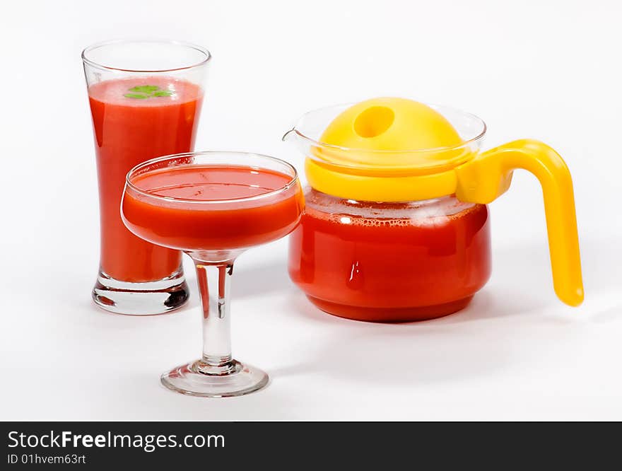 Carrot juice in glass carafe and two cocktail glasses. Carrot juice in glass carafe and two cocktail glasses.