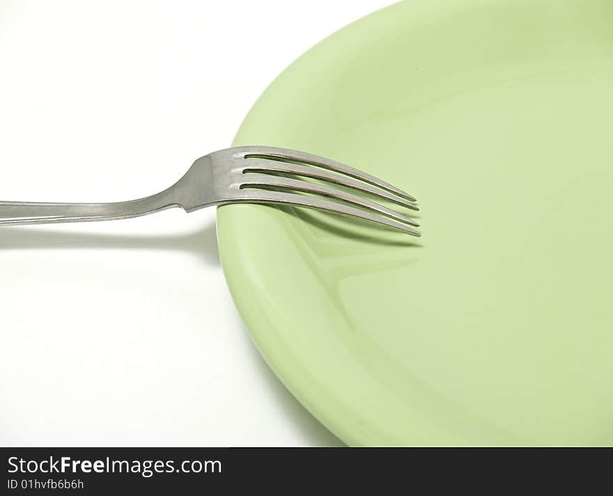 Plate and fork isolated on white background