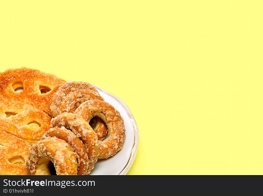 Various biscuit served on the plate. Yellow background. Various biscuit served on the plate. Yellow background.