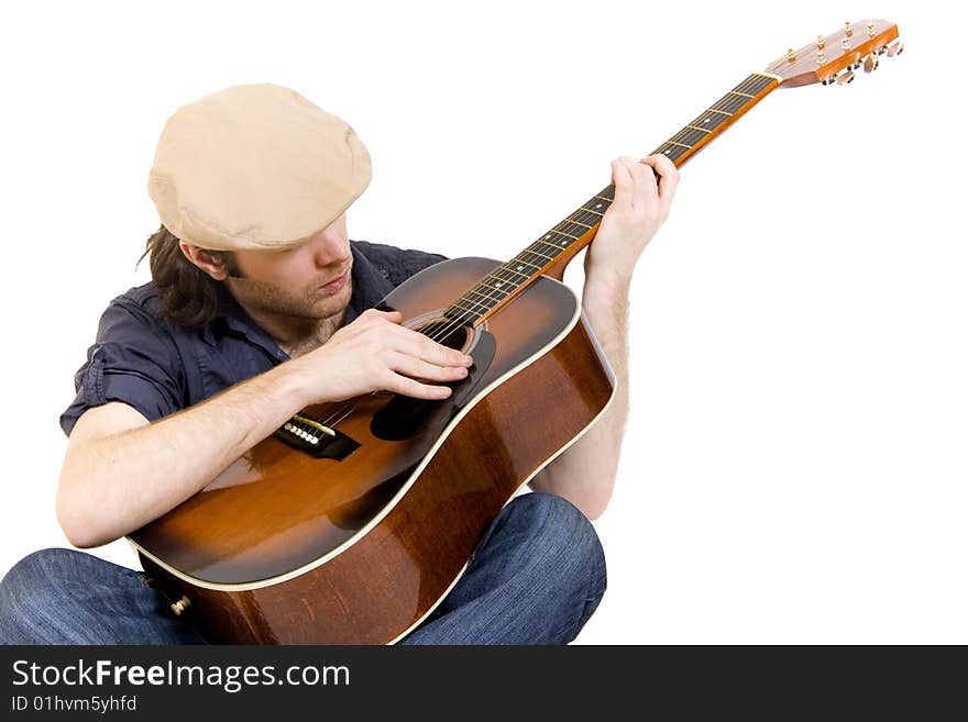 Guitarist playing an acoustic guitar seated