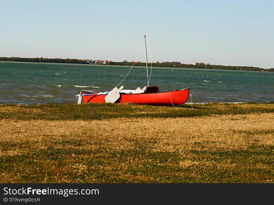 A red canoe on the shores of the Florida Gulf Coast