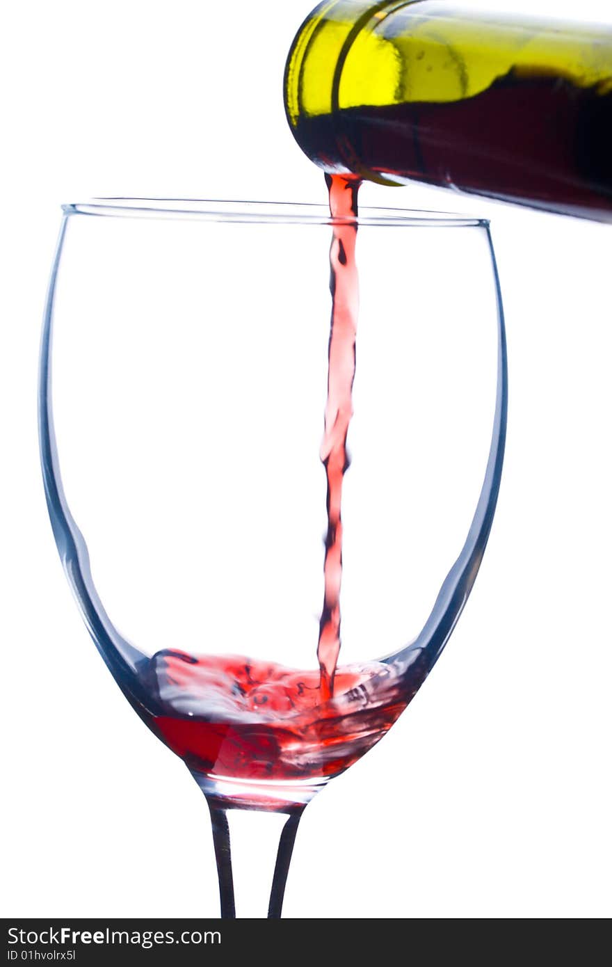 Close-up pouring a wine in glass, isolated on white