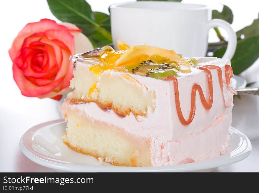 Piece of cake with fruits rose and cup