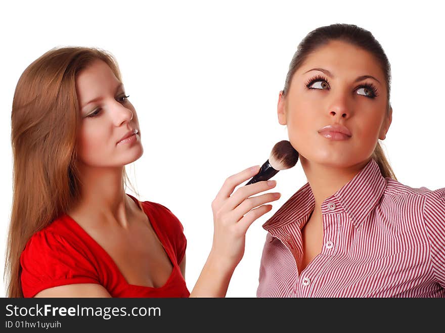 Two beautiful woman with brush for make-up