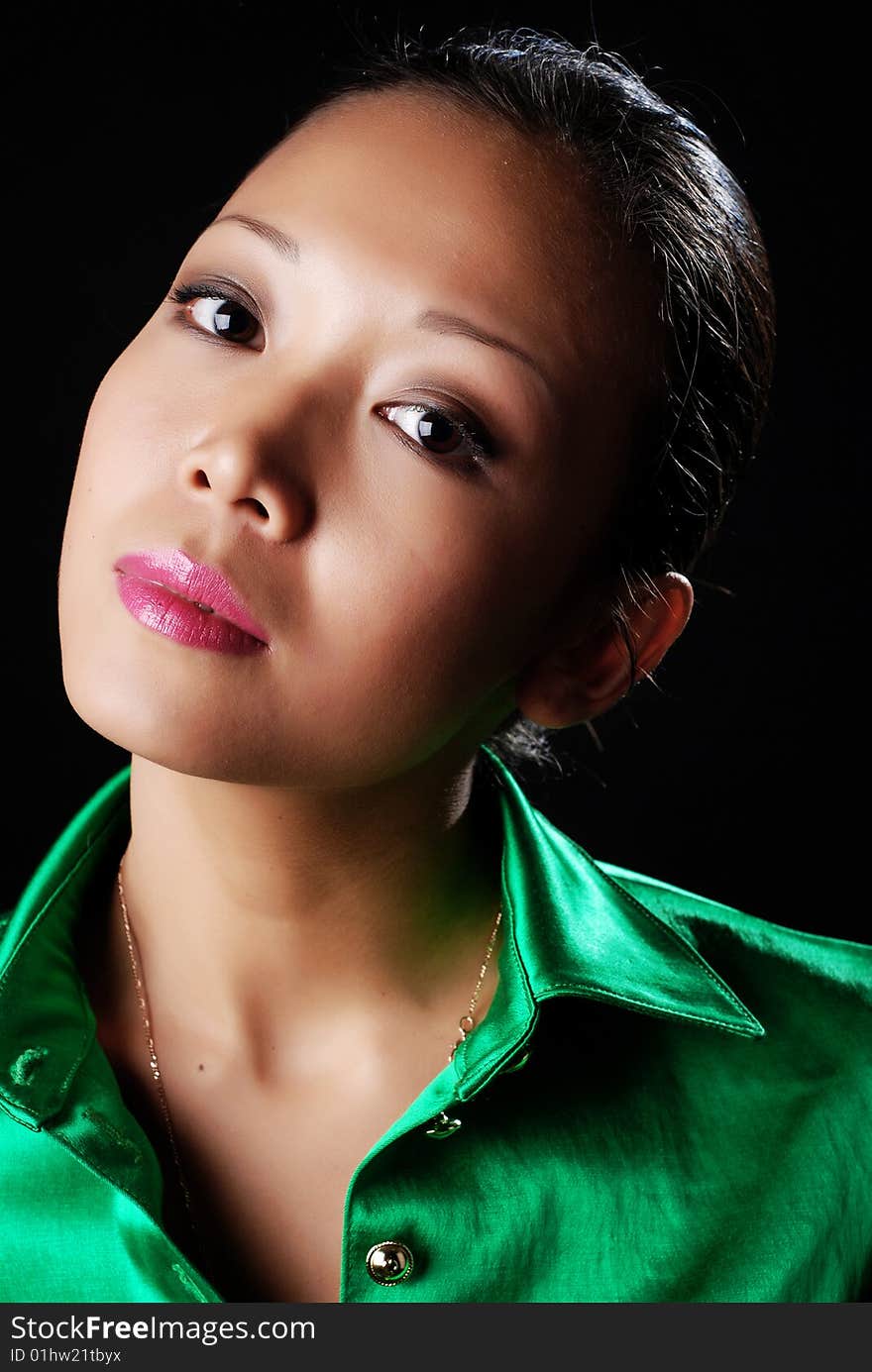 Portrait of a beautiful young woman in green shirt