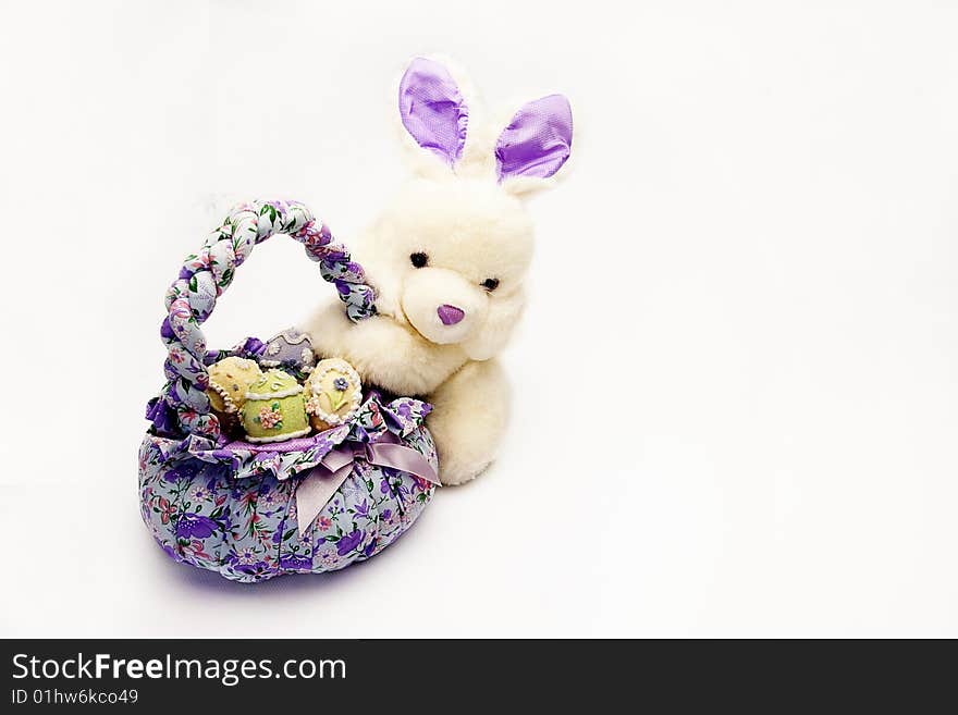 Isolated shot of a basket with easter eggs and bunny holding the basket. Isolated shot of a basket with easter eggs and bunny holding the basket.