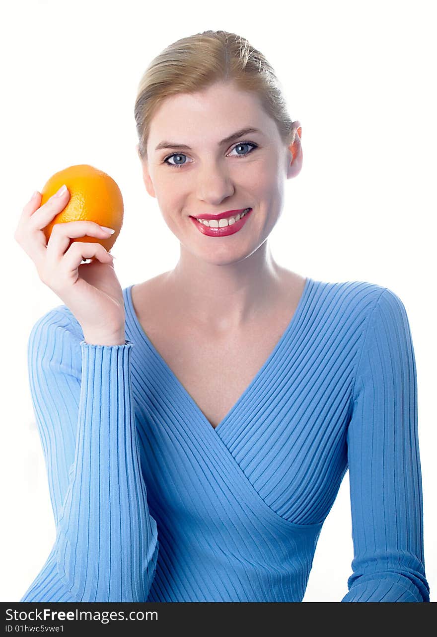 Portrait of the beautiful girl with an orange in hands