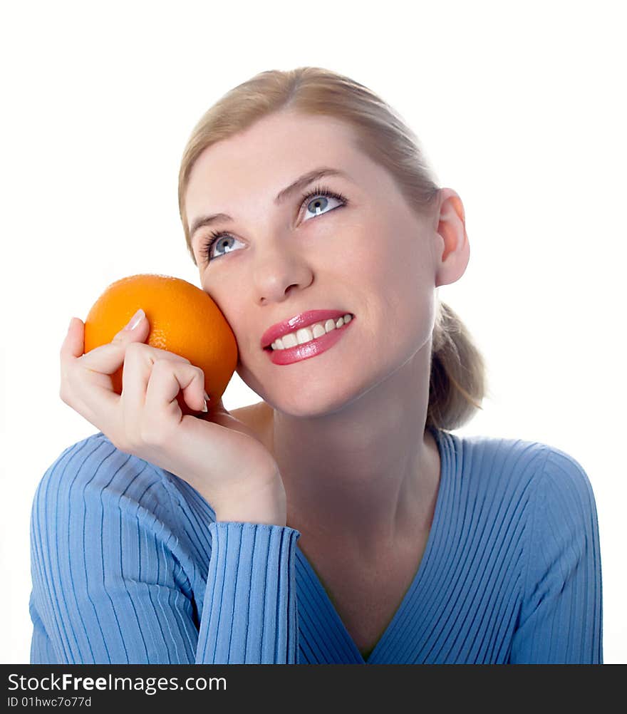 Portrait of the beautiful girl with an orange in hands