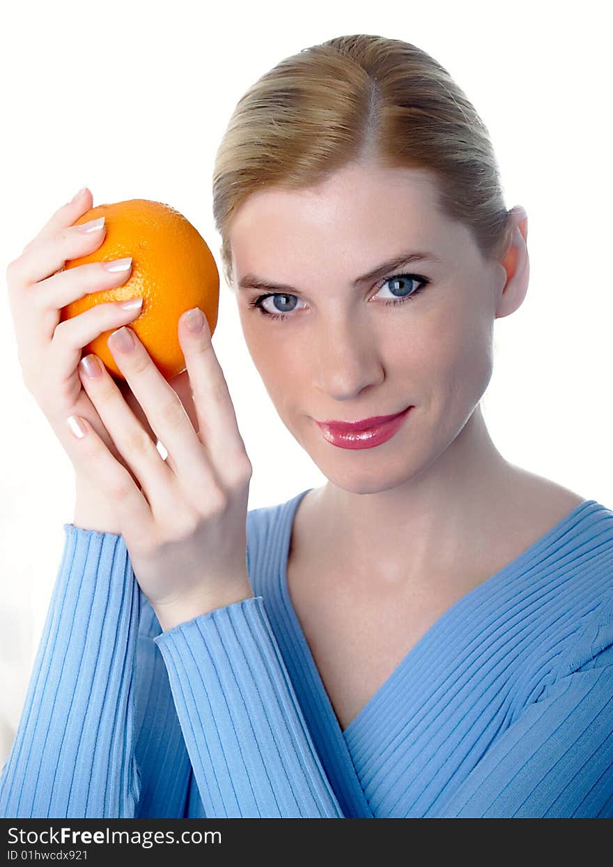 Portrait of the beautiful girl with an orange in hands