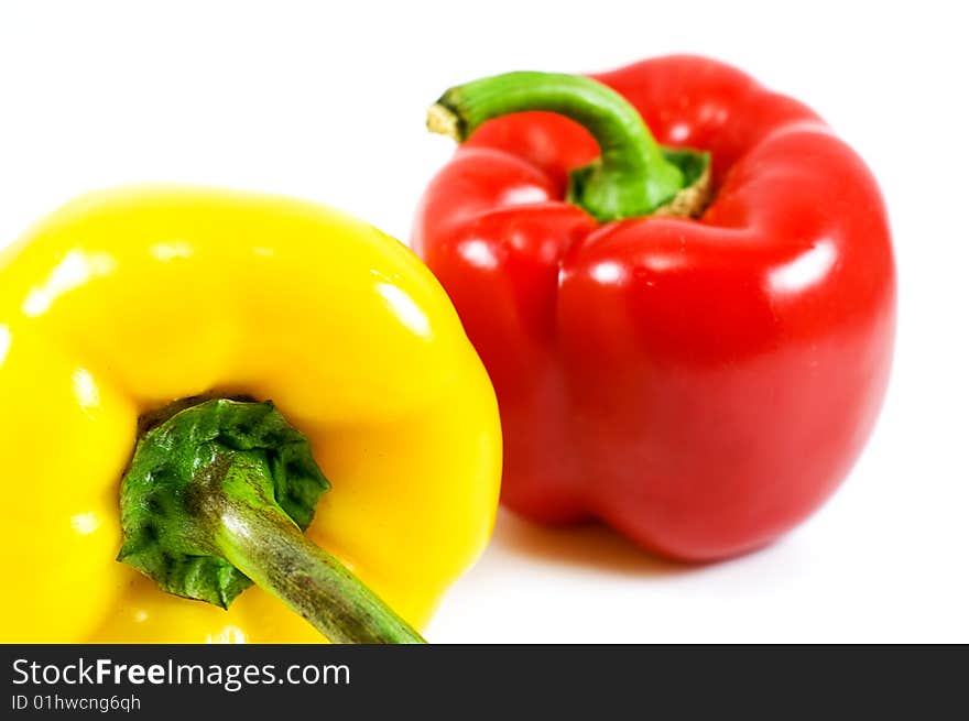 Red and yellow pepper over white. Red and yellow pepper over white