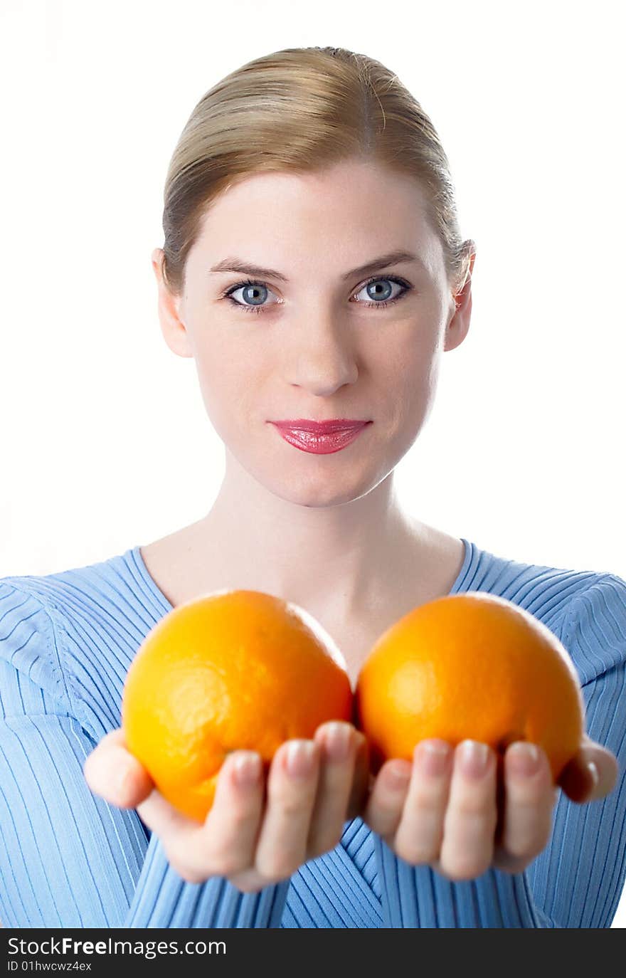 Portrait of the beautiful girl with an orange in hands