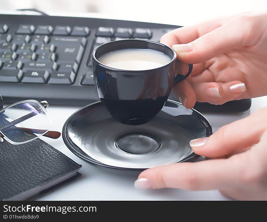 Hand with cup on a background of various subjects