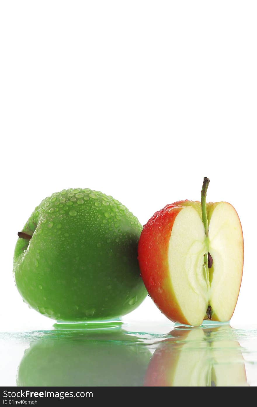 Green apple and slice of red apple