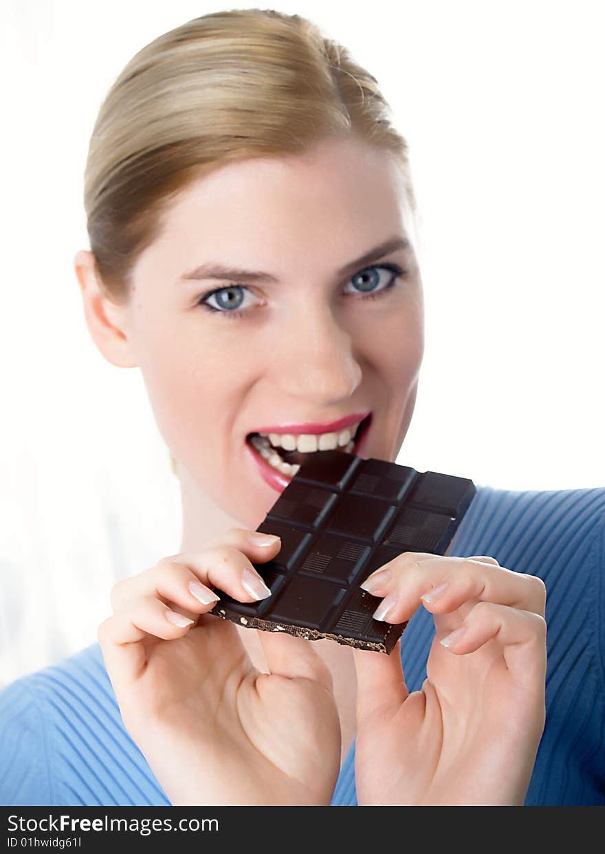 Portrait of the beautiful girl with a chocolate in a hand