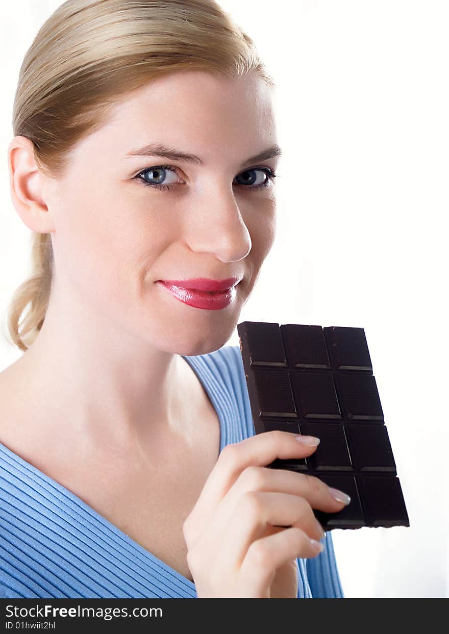 Portrait of the beautiful girl with a chocolate in a hand