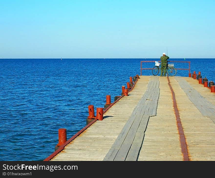 Fisher standing and looking in sea. Fisher standing and looking in sea