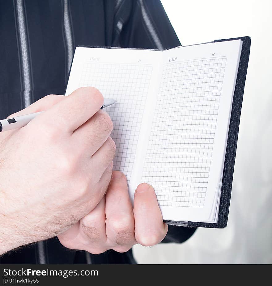 Closeup of mans hand going to write a business plan. Closeup of mans hand going to write a business plan