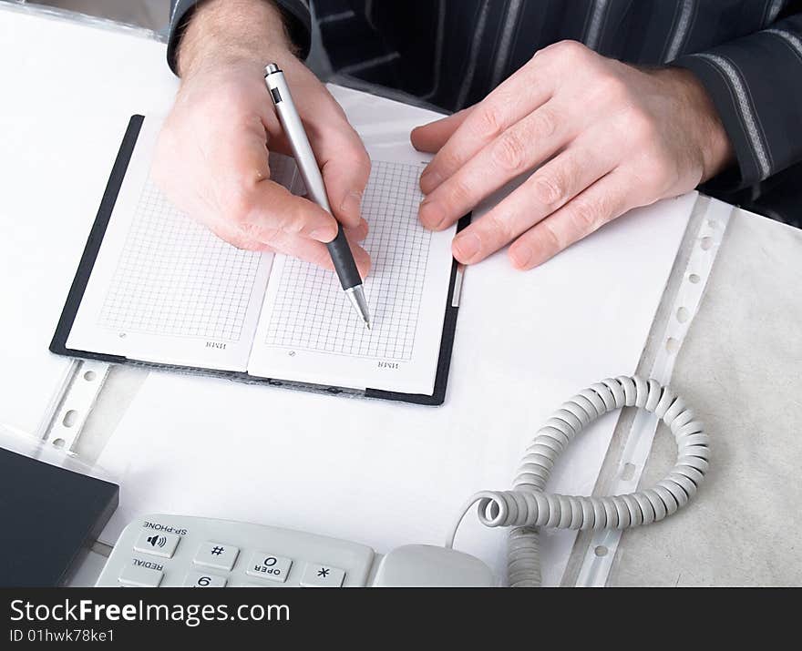 Closeup of mans hand going to write a business plan. Closeup of mans hand going to write a business plan