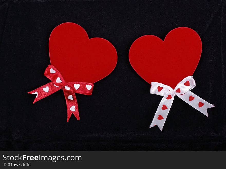 Two hearts with ribbons