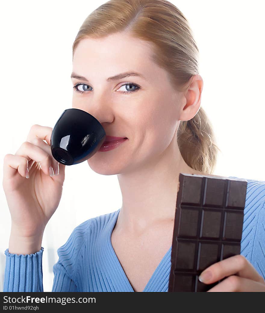 The beautiful girl with a coffee cup in a hand and  chocolate