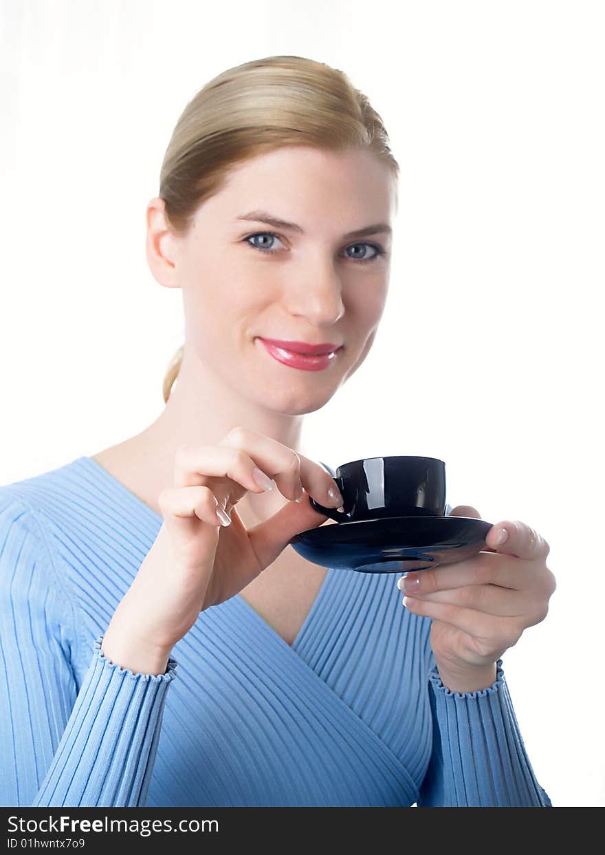 The beautiful girl with a coffee cup in a hand