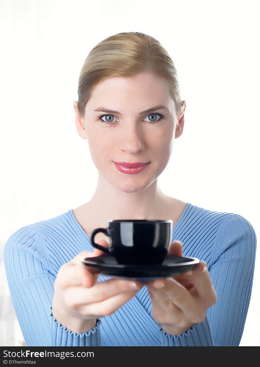 The beautiful girl with a coffee cup in a hand