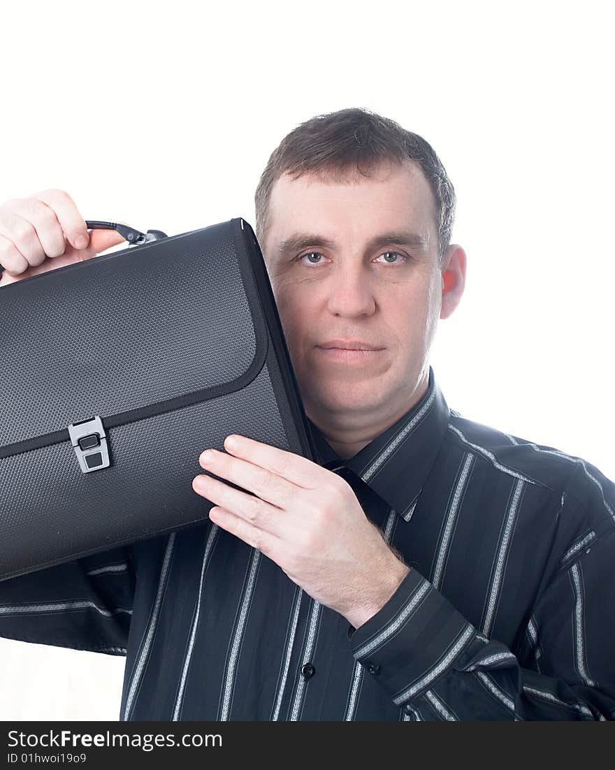 Portrait of the businessman in a dark shirt with a portfolio at office