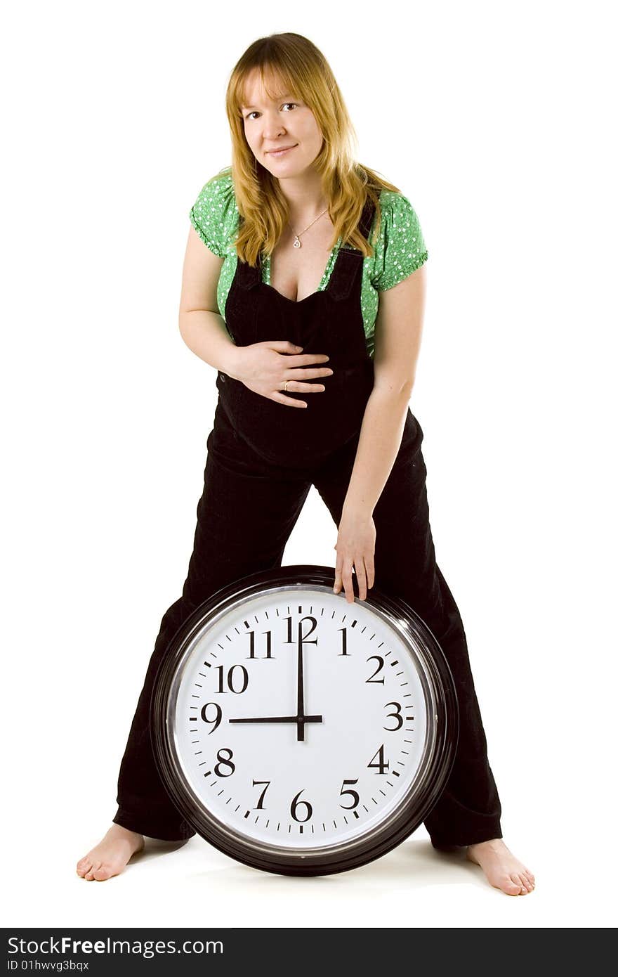 Pregnant woman with a clock on white background