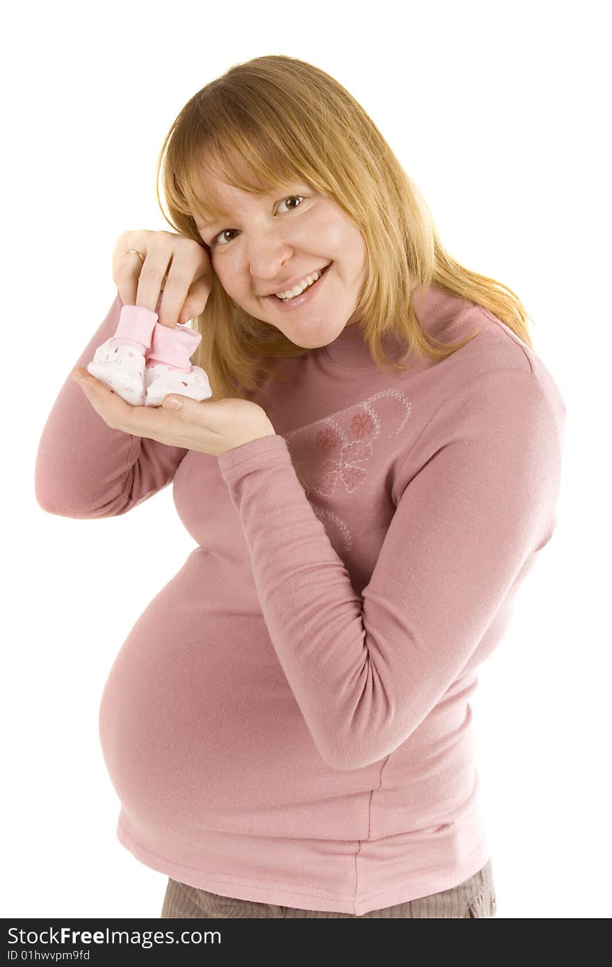 Pregnant woman holding pair of pink socks for baby girl