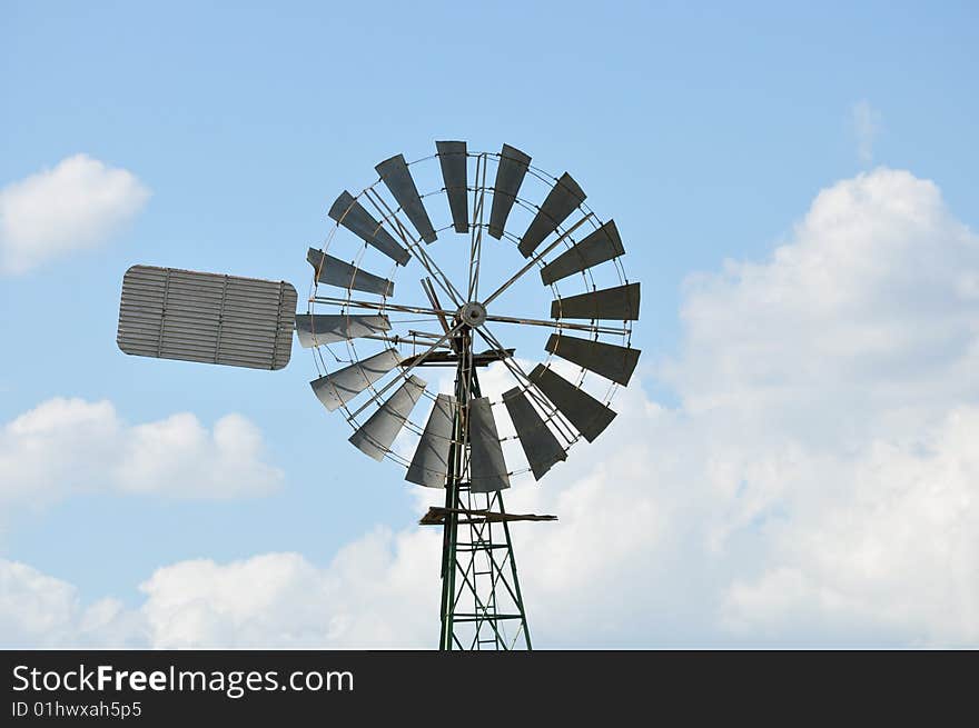 Windmill in the fields with clouds