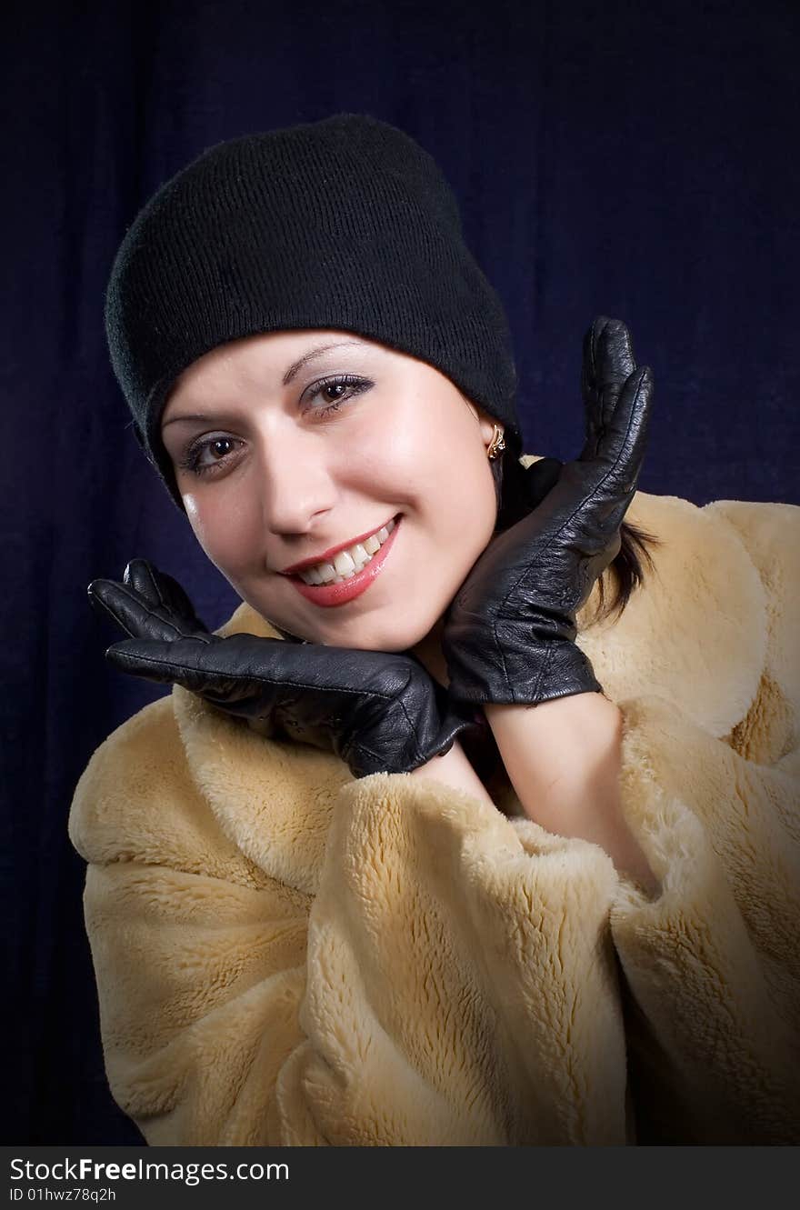 Merry girl in black hat on turn blue background. Merry girl in black hat on turn blue background