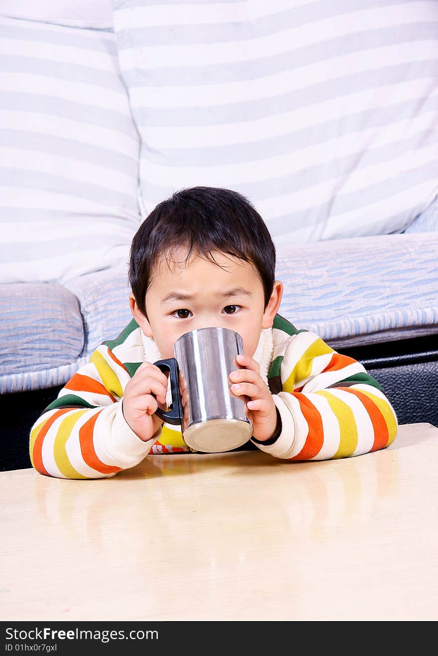 Boy Drinking Water Under Sofa