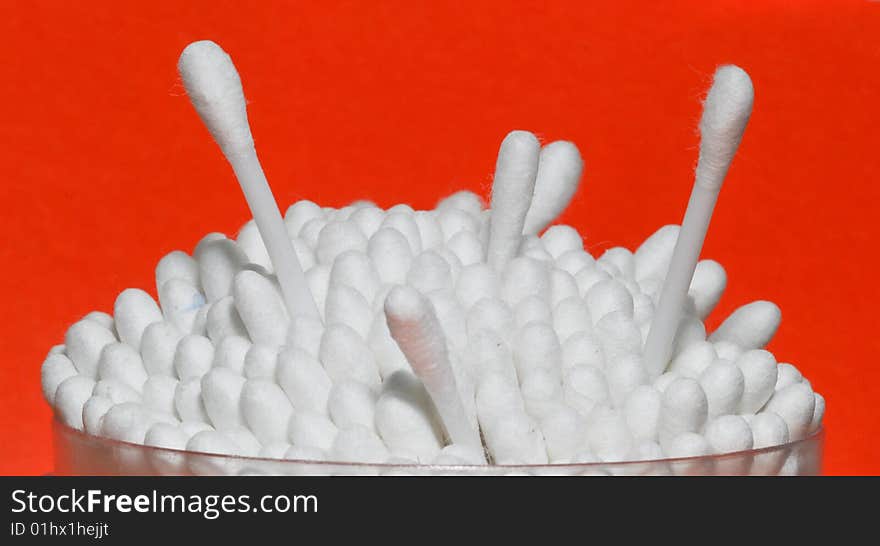 Cotton swabs on a red background