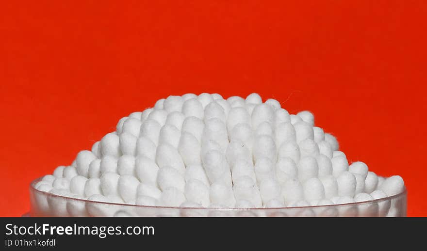 Cotton swabs on a red background